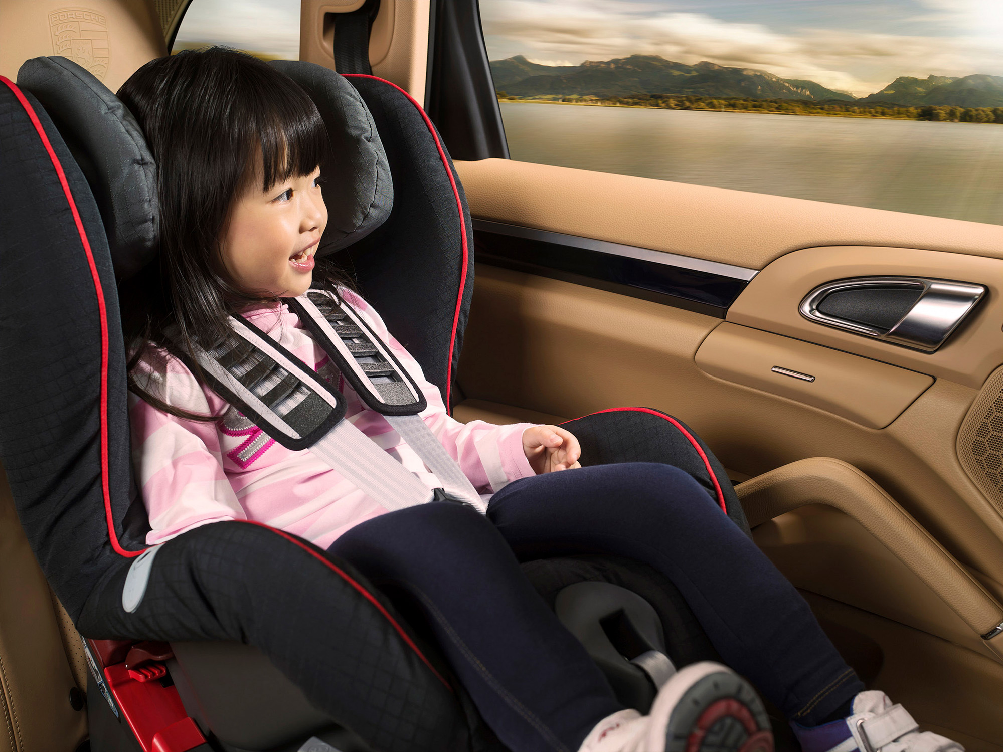 Commercial advertising lifestyle family and children photography services A child seated in a car seat, gazing out the window with wonder, skillfully captured as part of a commercial advertising lifestyle family and children photography campaign.