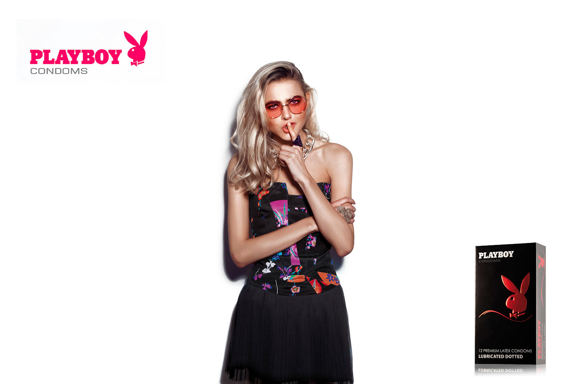 Commercial lifestyle photography services. Commercial lifestyle photography campaign for Playboy condoms, featuring a model in an alluring 'shhh' pose.