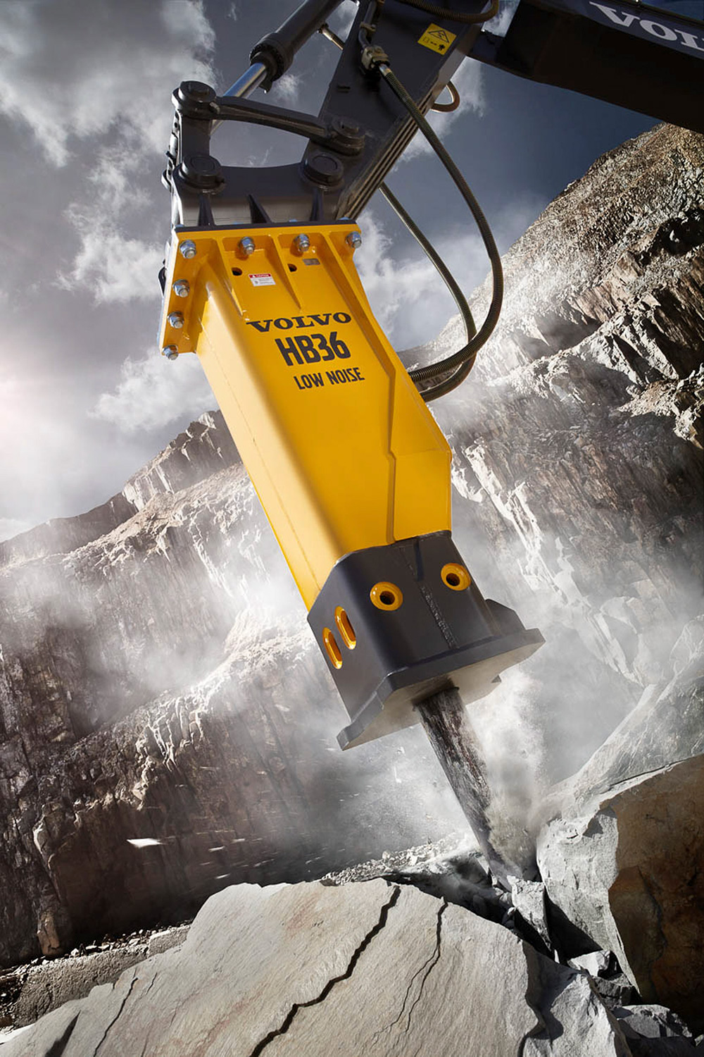 Construction equipment photography services The Volvo HB36 breaker skillfully cracks a rock, featured in a construction equipment photography campaign.