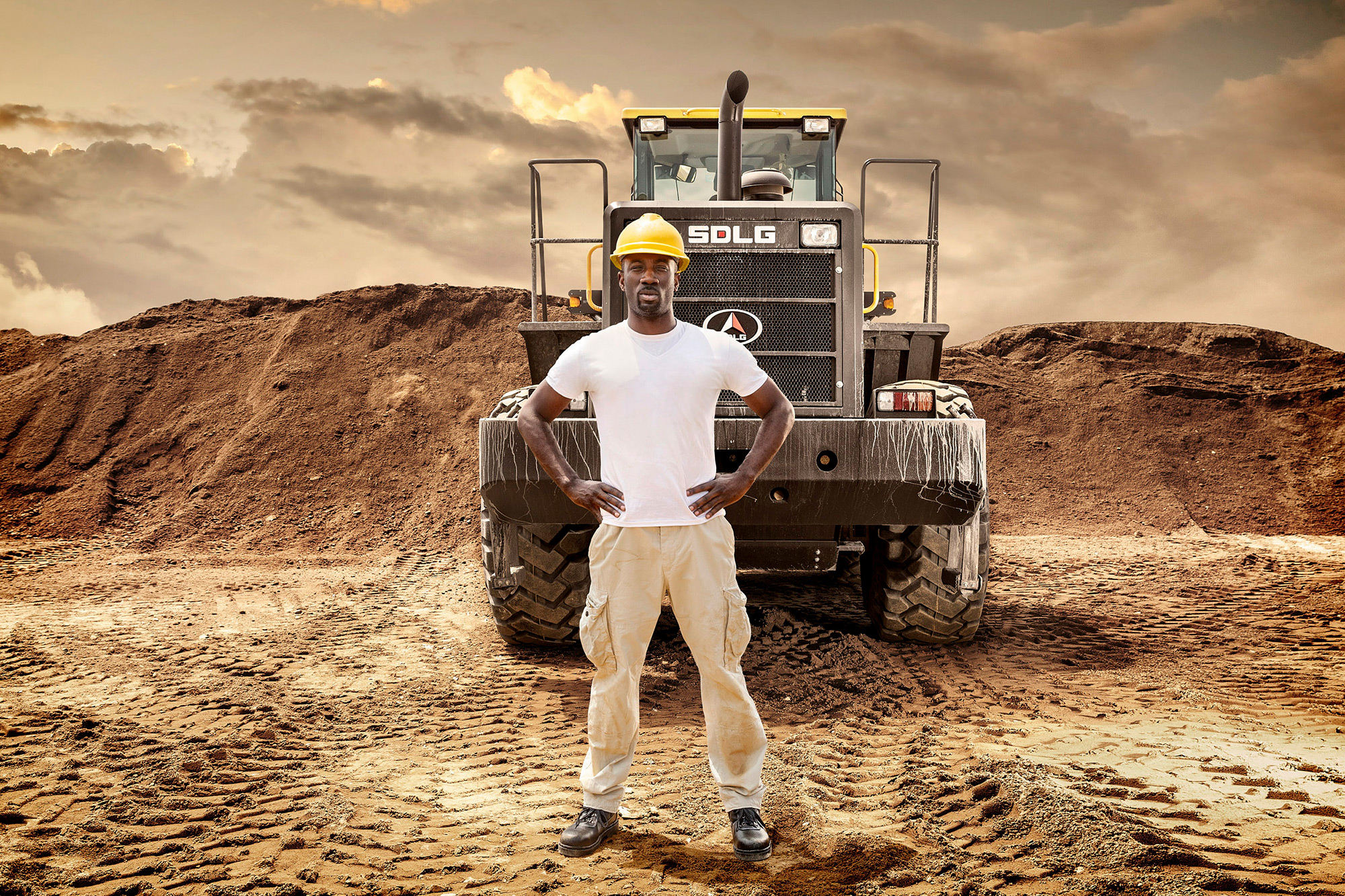 Construction equipment photography services Operator stands proudly in front of his SDLG wheel loader, a moment captured by construction equipment photography services.