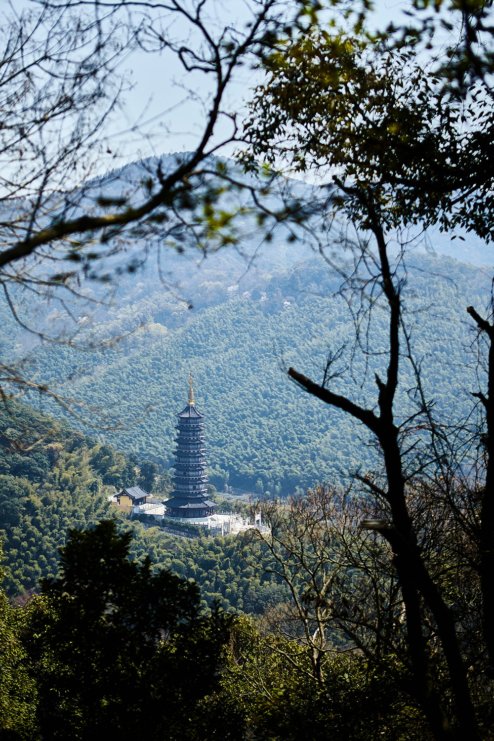Hotel and Hospitality destination Photography Traditional Chinese pagoda nestled in the serene mountains, featured in a hotel and hospitality destination photography campaign.