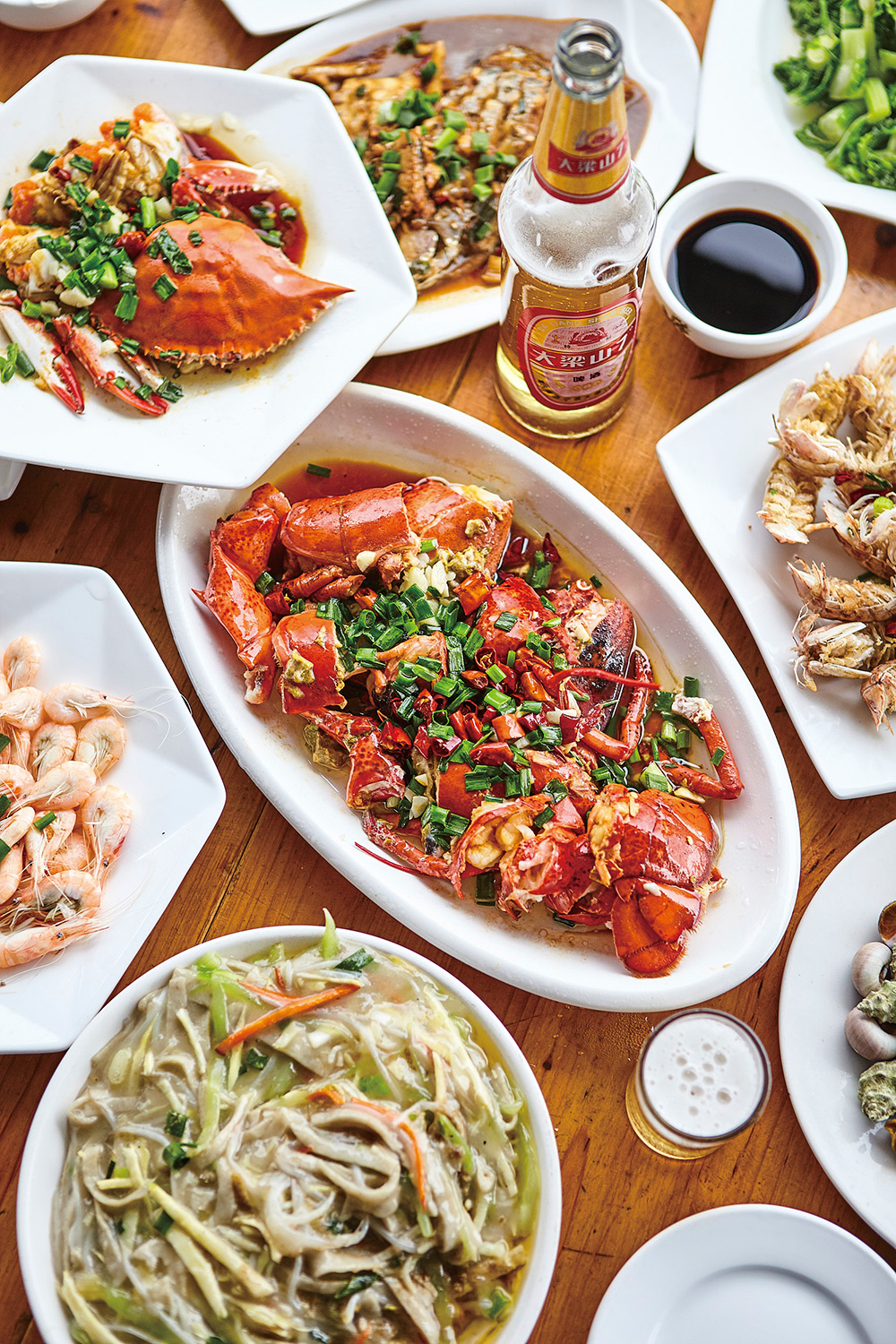 Hotel and hospitality food photography services A full table adorned with a sumptuous lobster and crab feast, artfully captured in a hotel and hospitality food photography campaign.