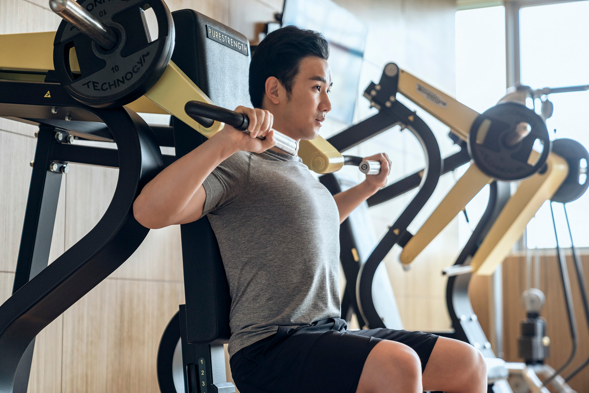 Hotel and hospitality lifestyle photography services Guest engaged in a workout session at the Four Seasons gym, captured in a hotel and hospitality lifestyle photography campaign.