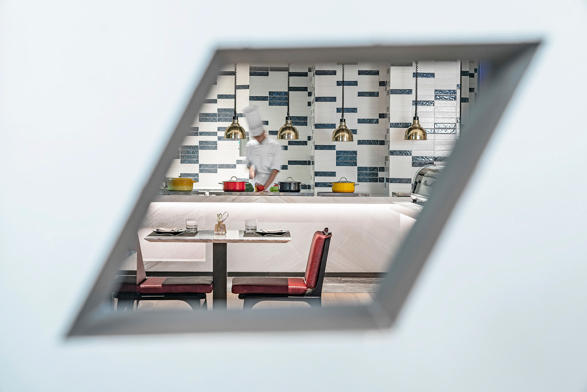 Hotel and hospitality staff photography services Chef hard at work in the kitchens of The G hotel in Shenzhen, featured in a hotel and hospitality staff photography campaign.