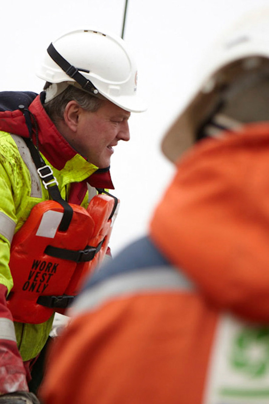 Industrial naval photography services The staff and crew of the Dockwise semi-submersible vessel preparing to launch a small boat into the water, captured as part of industrial naval photography services.