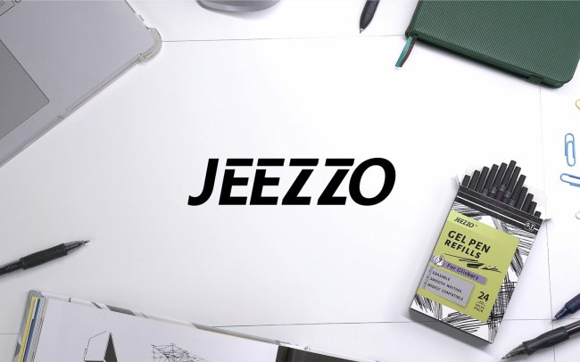 A case of gel pen refills sit on a table surrounded by other props. Cover photo for a professional product video produced in studio for Jeezzo gel pen refills.