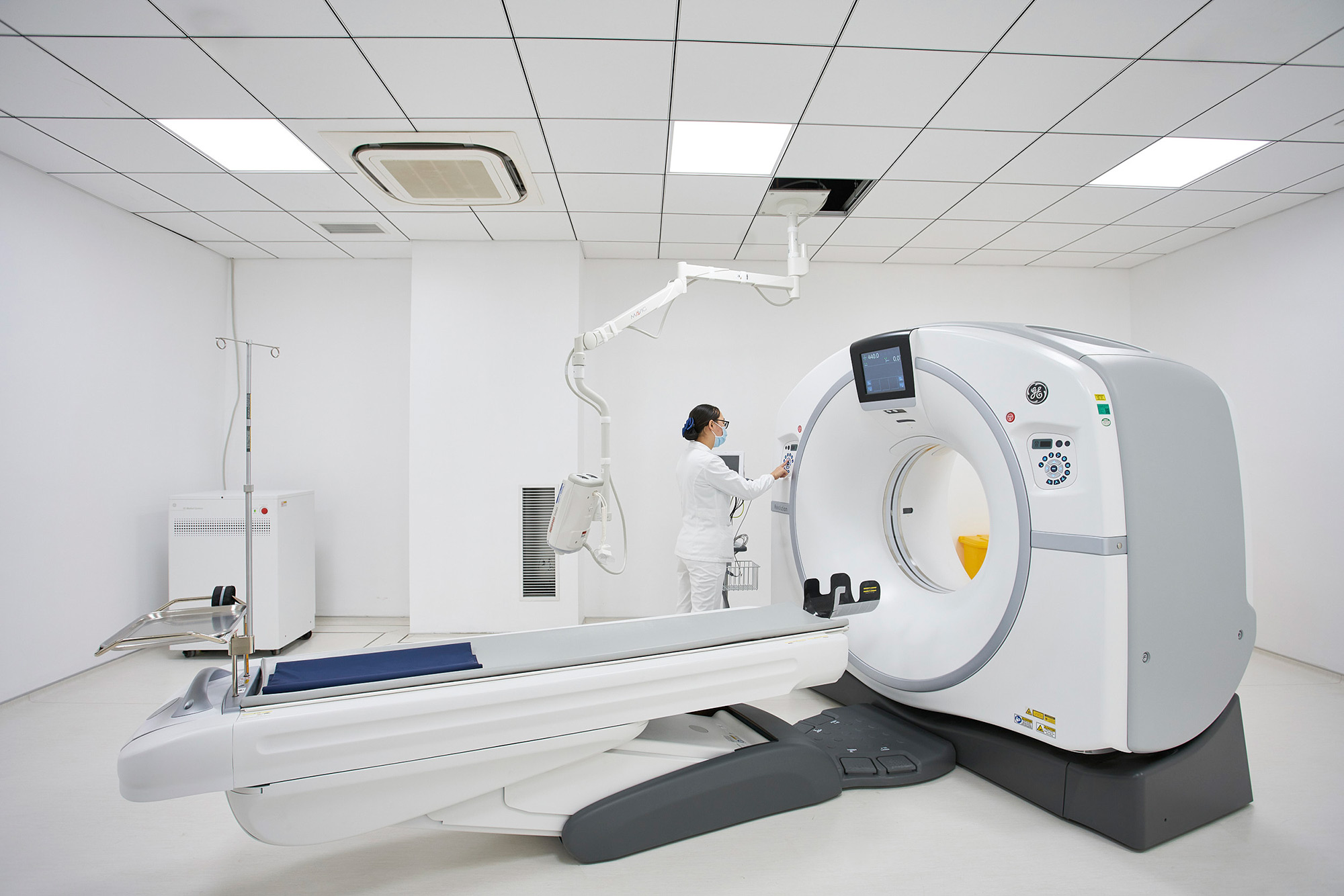 Medical Science Photography Services Attentive nurse inspecting and preparing an MRI station for the next patient, showcasing our Medical Science Photography Services.