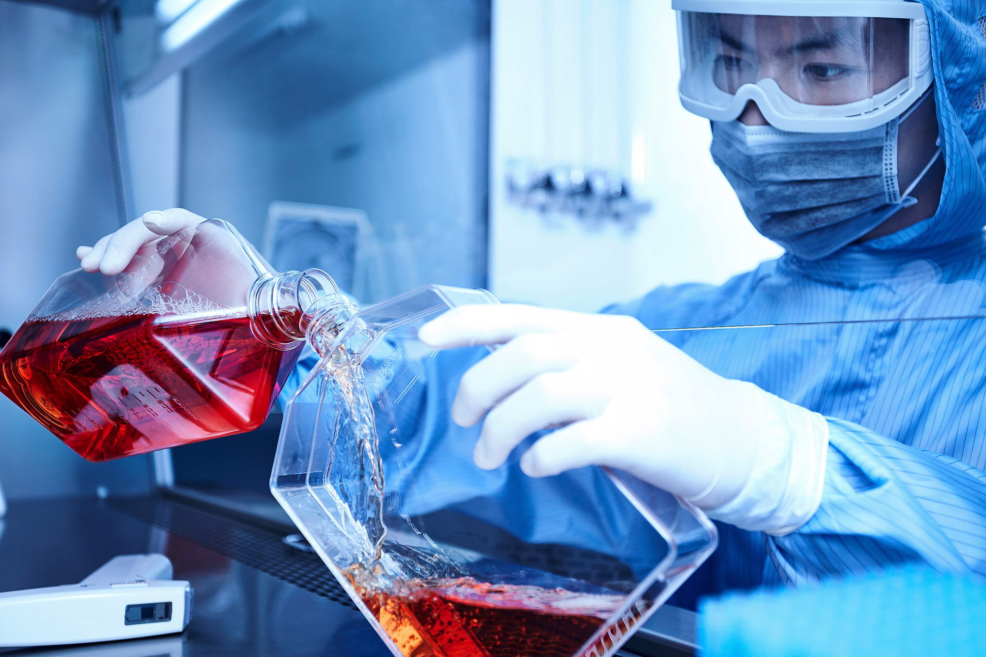 Science and technology Photography services A scientist pours a solution in a high security gene laboratory for a science and technology photography assignment.