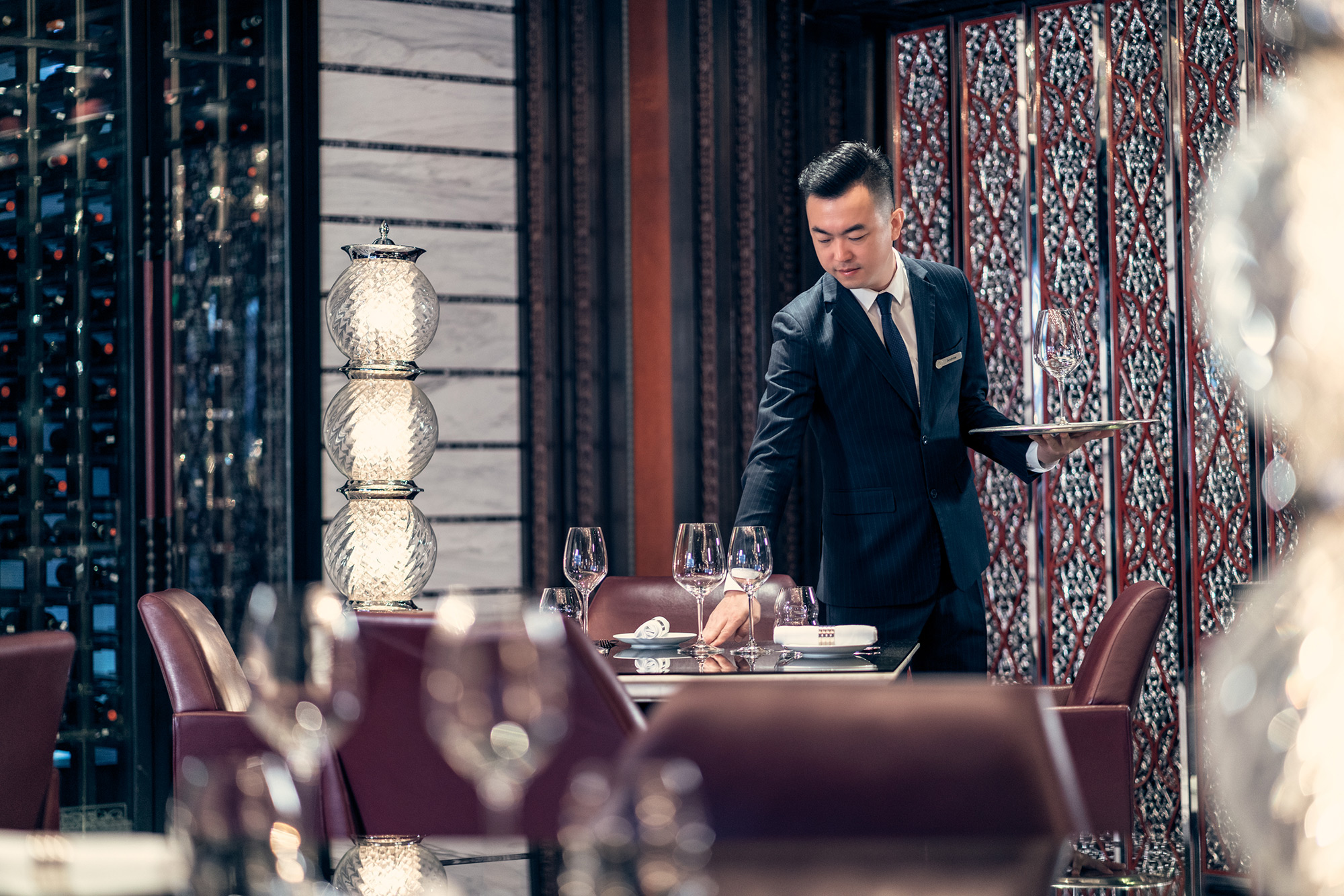 PhilippeRoy_Hospitality_1204 Hotel photography illustrating Marriott Hotel guest services personnel meticulously setting tables, underscoring attention to detail and service quality.