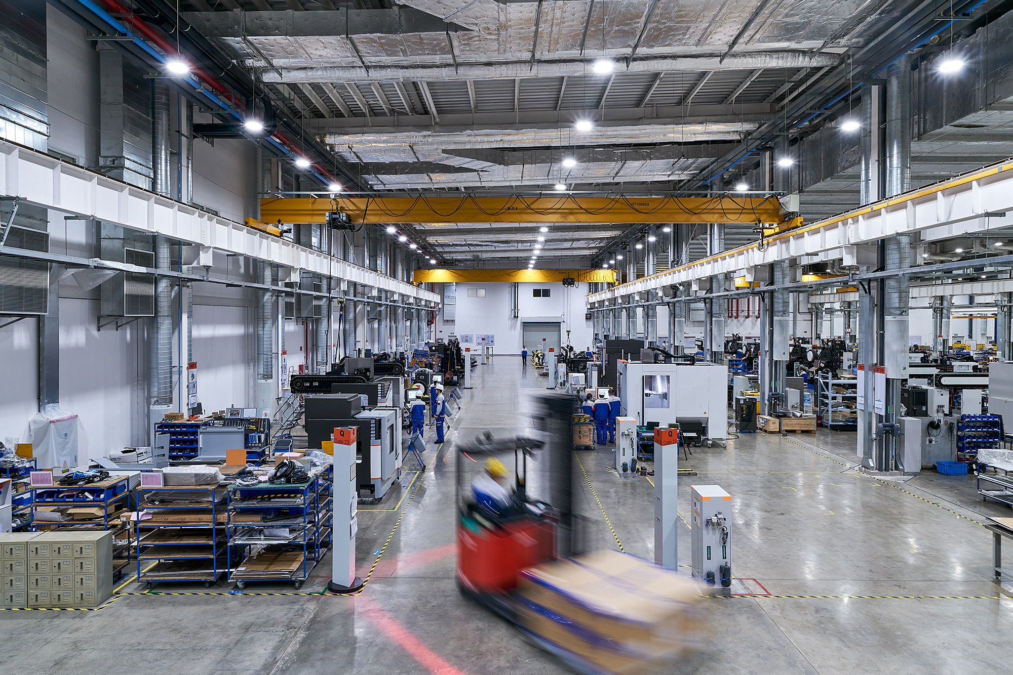 PhilippeRoy_Industrial_1727 Abstract industrial architecture photography capturing the interior of the Georg Fischer factory with an artistic blur, evoking a sense of movement and energy in the industrial environment.