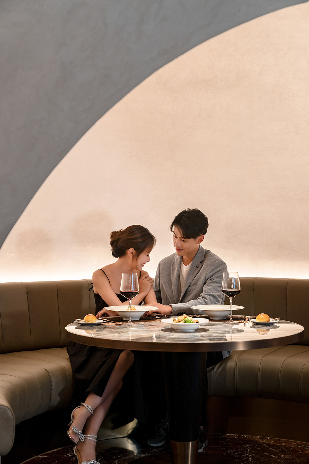 PhilippeRoy_Lifestyle_0139 Lifestyle hotel photography of a young couple sharing a romantic dinner, showcased in a Marriott Hotels and Resorts customer story.