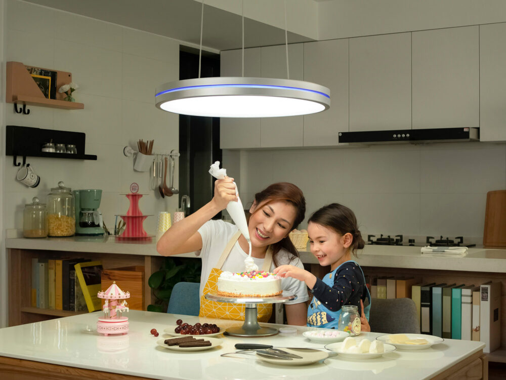 A mother and daughter frosting a cake in an advertising lifestyle image, showcasing family and children photography.