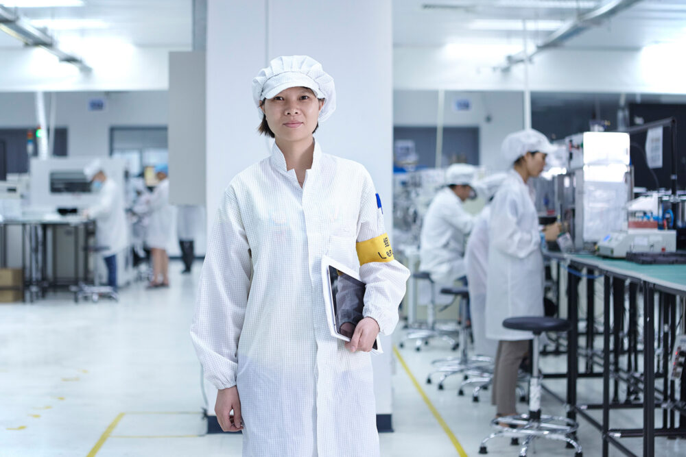 Corporate portrait of an employee on the factory floor at Flextronics.