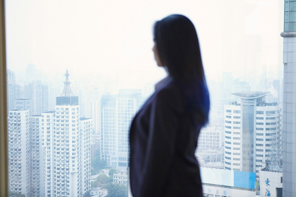 Female professional's corporate portrait with a backdrop of Shanghai city, photographed for Image Source.