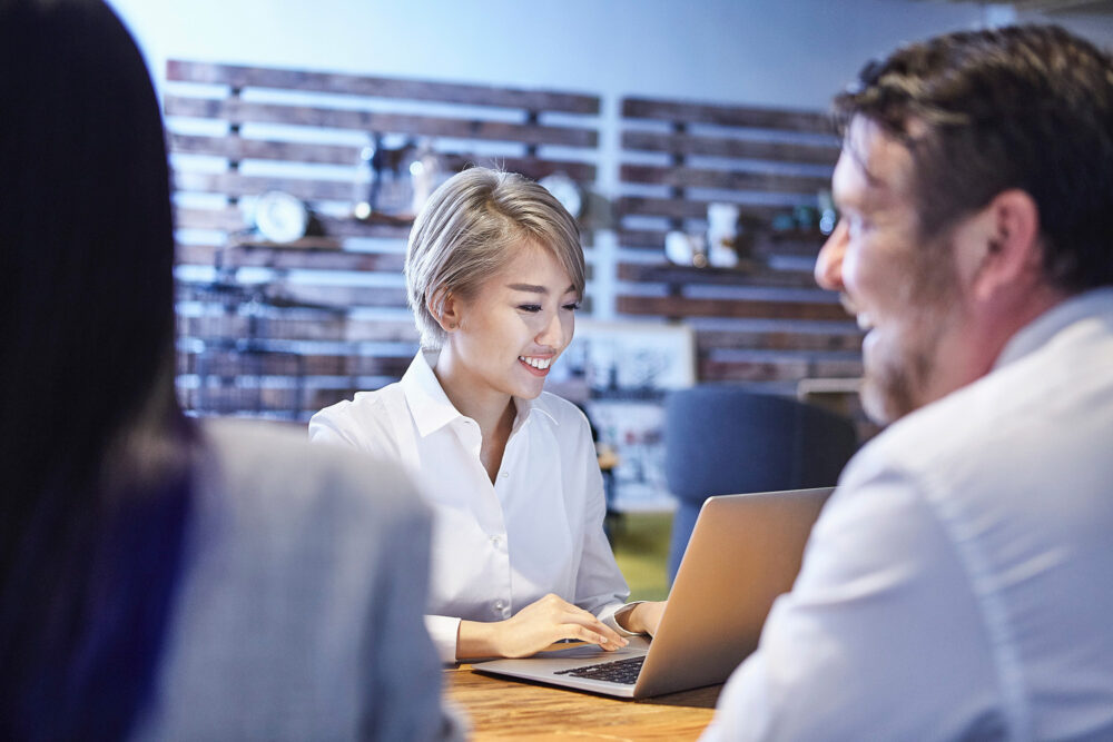 Business team engaged in a meeting at Image Source, photographed for a corporate photography campaign emphasizing teamwork.