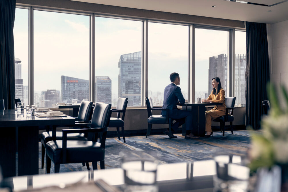 Business meeting in the top-floor business lounge at Four Seasons Hotel Beijing, captured for a corporate photography campaign.
