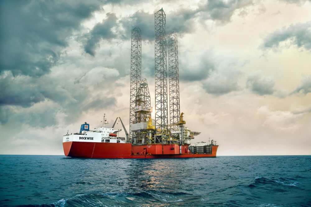 Hero image of the Treasure vessel with an oil rig, part of Dockwise's naval industrial photography.