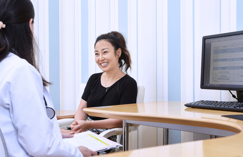 Client consulting with a doctor at Ferguson Women's Health, captured for a medical science photography campaign.