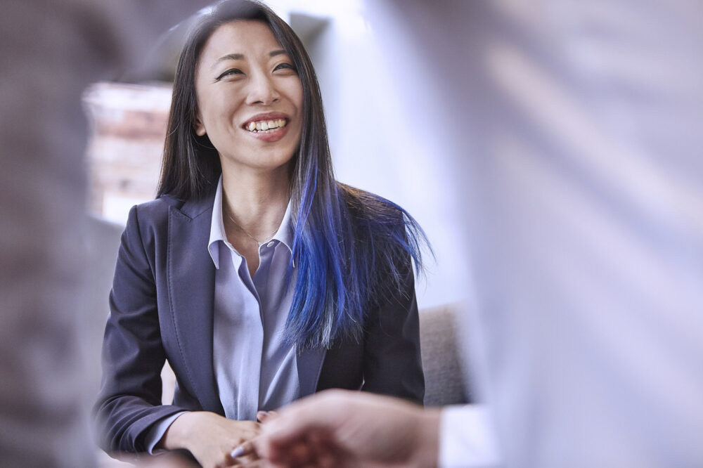 Female manager laughing during a meeting at Image Source, captured for a corporate photography session.
