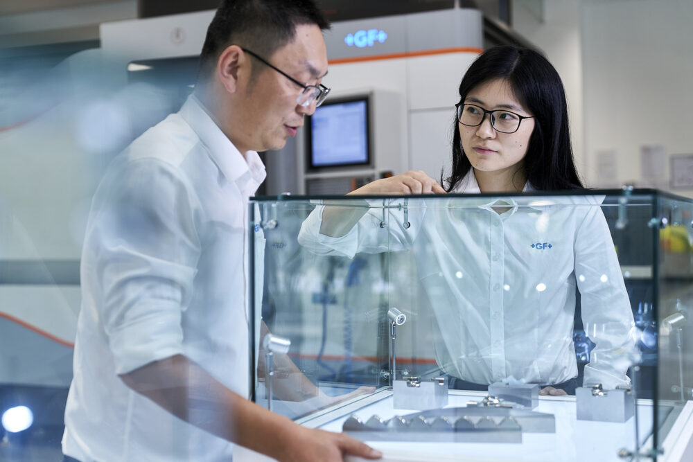 Two employees examining factory samples at Georg Fischer, captured for their corporate photography collection.