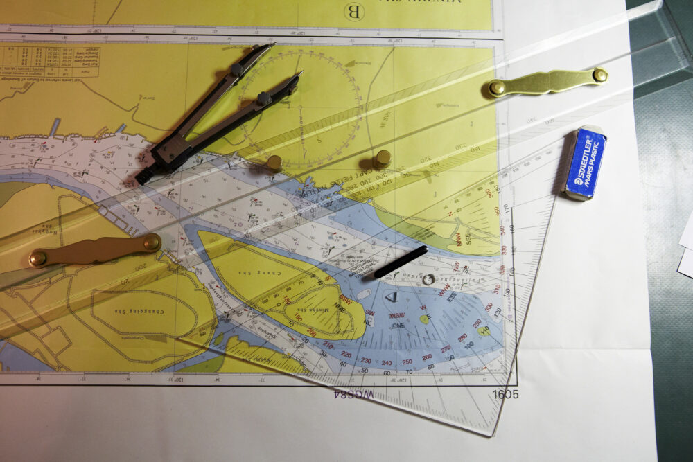 Naval engineer's desktop with a depth map, photographed for Dockwise's naval industrial photography.