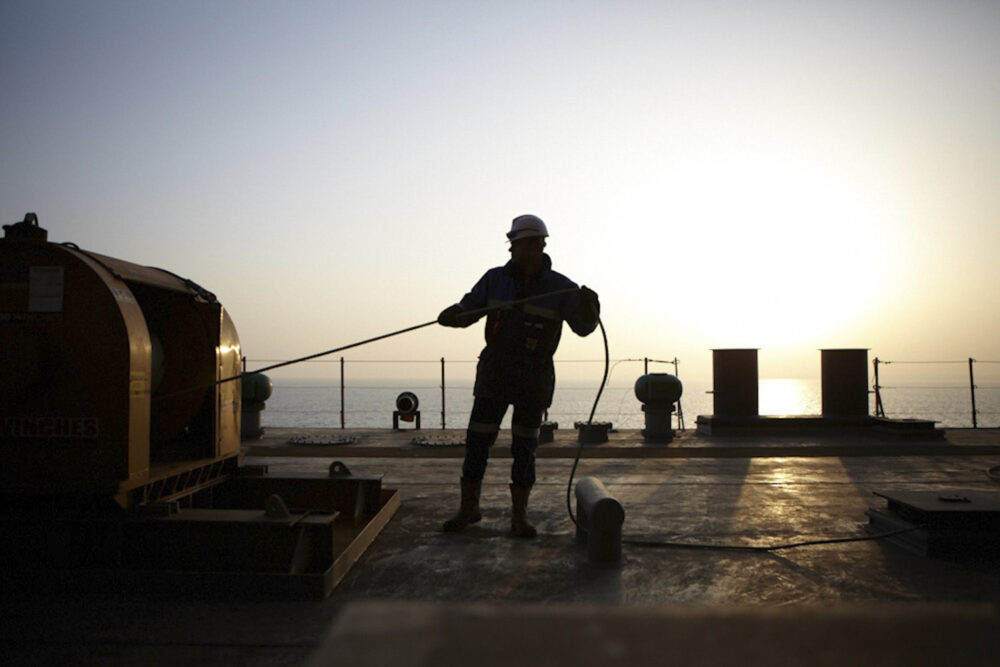 Naval engineer at work on a ship, part of Dockwise's naval industrial photography campaign.