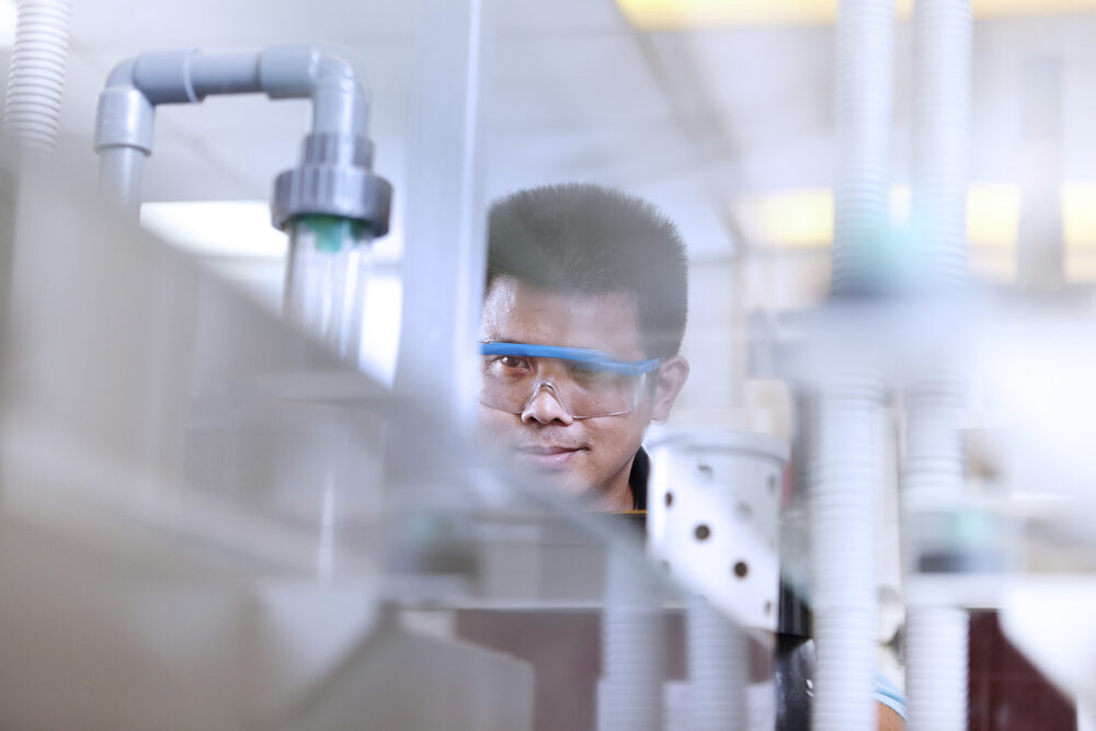 Engineer working on the water system pipes, featured in industrial photography for Georg Fischer.