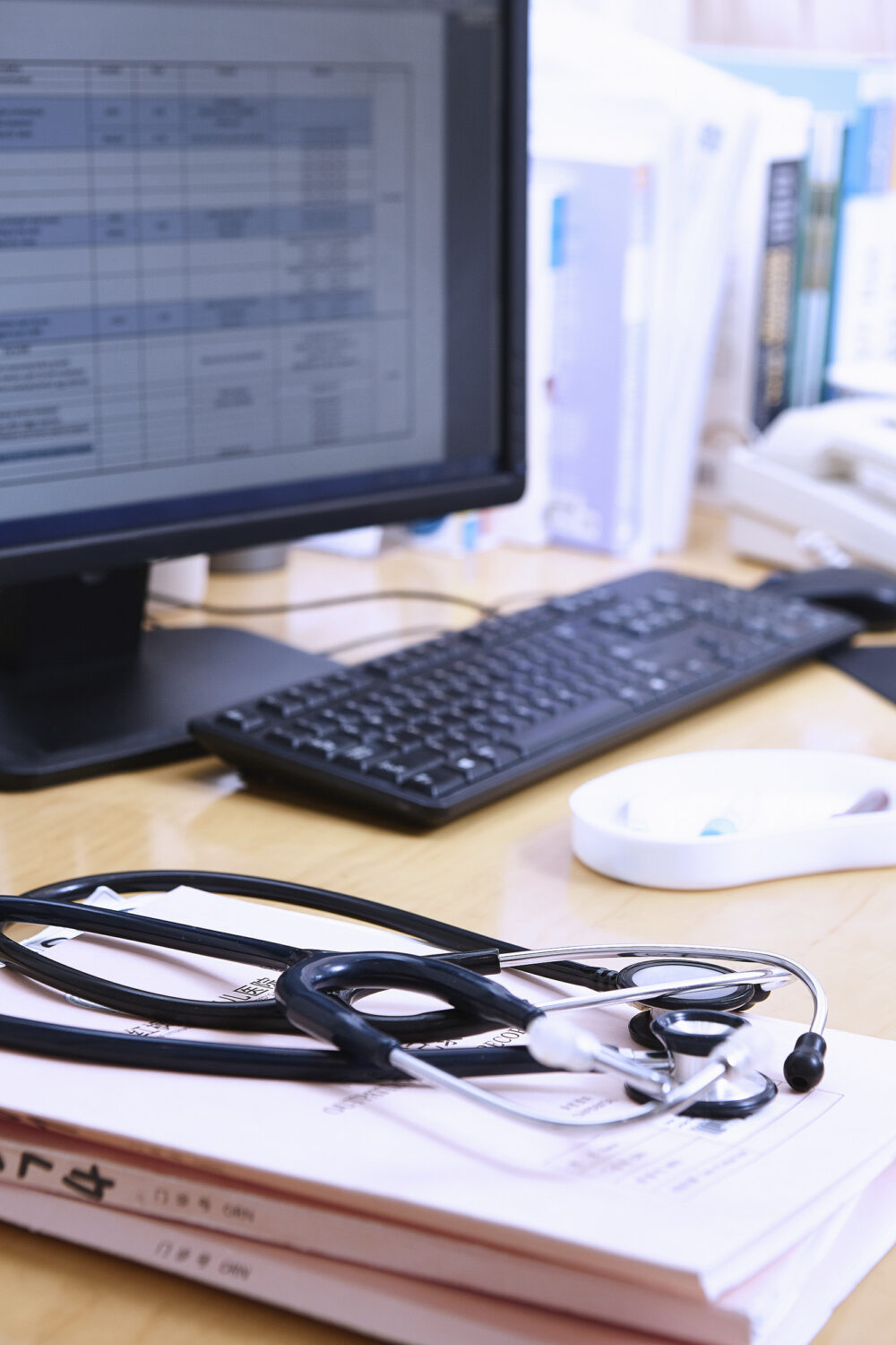Doctor's desk setup in a hospital setting, photographed for Ferguson Women's Health, highlighting science and technology aspects.