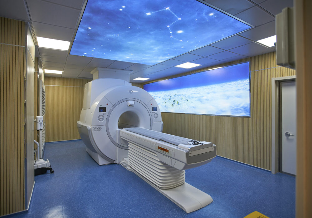 An MRI scanner room bathed in the precise illumination of OSRAM lighting, exemplifying the intersection of cutting-edge technology and medical science for a dedicated photography campaign.