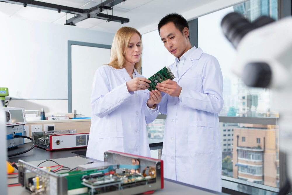Engineers examining medical equipment, photographed for Richard Wolf's science and technology promotion.